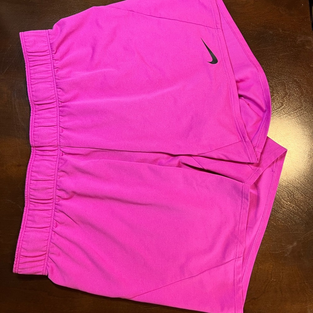 Hot pink Nike shorts with foldable waist band and black detail, size M